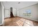 Sun-filled living area featuring wood floors, staircase, and a large window with neighborhood views at 103 Clydebank Pl, Kissimmee, FL 34758