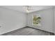 Empty bedroom features a ceiling fan, neutral walls, gray floors, and a window for natural light at 105 3Rd Eloise St, Winter Haven, FL 33880
