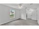 Bright, airy bedroom features a ceiling fan and neutral walls, plus access to the bathroom at 105 3Rd Eloise St, Winter Haven, FL 33880