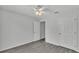 This spacious bedroom is a blank canvas with gray floors and a white ceiling fan at 105 3Rd Eloise St, Winter Haven, FL 33880