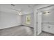 Relaxing bedroom with gray floors features a ceiling fan, a window and a pass-through to the bath at 105 3Rd Eloise St, Winter Haven, FL 33880