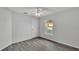 A tranquil bedroom with gray flooring, white trim and neutral walls is bathed in natural light at 105 3Rd Eloise St, Winter Haven, FL 33880