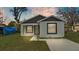 Charming single-story home with white stucco and black trim, featuring a well-maintained front lawn and a modern design at 105 3Rd Eloise St, Winter Haven, FL 33880