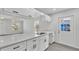 Bright, updated kitchen features white cabinets, modern countertops, stainless sink and door to the exterior at 105 3Rd Eloise St, Winter Haven, FL 33880