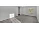 Bright open-concept living space with modern gray flooring, white trim, and plenty of natural light at 105 3Rd Eloise St, Winter Haven, FL 33880