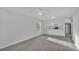 Open-concept living space with modern gray flooring and a view into the bright, white kitchen at 105 3Rd Eloise St, Winter Haven, FL 33880