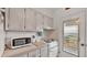 Kitchen with white appliances and light wood cabinets at 1600 W Lake Parker Dr # B9, Lakeland, FL 33805