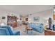 Living room with blue sofas and a view into the dining area at 1600 W Lake Parker Dr # B9, Lakeland, FL 33805