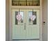 Close-up of a double front door, adorned with Valentine's Day decorations and glass panels at 1640 Taylor Landing Dr, Bartow, FL 33830