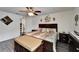 Inviting main bedroom featuring wood-look floors, ceiling fan, and decorative wall accents at 1640 Taylor Landing Dr, Bartow, FL 33830