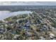 Expansive aerial view of a suburban neighborhood with mature trees, a tranquil lake, and well-maintained homes at 1841 Casco St, Lakeland, FL 33801