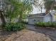 Backyard featuring tropical landscaping, brick-paved area, and a storage shed for additional space and outdoor relaxation at 1841 Casco St, Lakeland, FL 33801