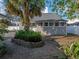 Charming backyard with a lush tropical garden bed and brick-paved area, creating a tranquil outdoor space at 1841 Casco St, Lakeland, FL 33801