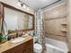 Bathroom with tiled shower/tub, granite vanity, and decorative mirror at 1841 Casco St, Lakeland, FL 33801