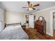 Bedroom with ceiling fan, wood floors, and decorative wood dresser at 1841 Casco St, Lakeland, FL 33801