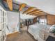Bedroom features a bed, wood accents, and an open ceiling design with exposed beams at 1841 Casco St, Lakeland, FL 33801