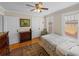Cozy bedroom featuring hardwood floors, ceiling fan, and natural lighting at 1841 Casco St, Lakeland, FL 33801