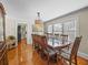 Traditional dining room with hardwood floors, a large wood table, and natural light from the windows at 1841 Casco St, Lakeland, FL 33801