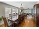 Elegant dining room with a long wooden table, hardwood floors and views into the living room at 1841 Casco St, Lakeland, FL 33801