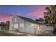 Inviting home exterior showcasing gray siding, a chimney, and manicured landscaping for charming curb appeal at 1841 Casco St, Lakeland, FL 33801