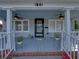 Inviting front porch with ceiling fans, white railings, and space for seating arrangements at 1841 Casco St, Lakeland, FL 33801