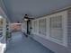 Spacious front porch with neutral paint, multiple windows and a pair of fans at 1841 Casco St, Lakeland, FL 33801