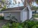 Detached two-car garage with white doors and lush landscaping, providing secure parking and an appealing aesthetic at 1841 Casco St, Lakeland, FL 33801