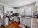 Bright kitchen with white cabinets, stainless steel appliances, granite countertops, and tile backsplash at 1841 Casco St, Lakeland, FL 33801