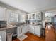 Charming kitchen with white cabinets, granite counters, stainless appliances, and hardwood floors at 1841 Casco St, Lakeland, FL 33801