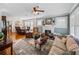 Open concept living room with a fireplace, hardwood floors, natural light and views into the dining room at 1841 Casco St, Lakeland, FL 33801