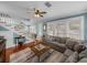 Comfortable living room with hardwood floors, lots of natural light, a gray sectional, and a white staircase at 1841 Casco St, Lakeland, FL 33801