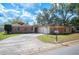 Charming single-story brick home with a circular driveway, two-car garage, and well-maintained front lawn at 1925 John Arthur Way, Lakeland, FL 33803