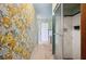 Hallway with floral wallpaper, a shower room, and a door to the exterior at 1925 John Arthur Way, Lakeland, FL 33803