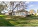 Expansive backyard showcasing lush green grass and mature trees, creating a serene outdoor space at 1961 Rocky Pointe Dr, Lakeland, FL 33813