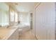 Well-lit bathroom with soaking tub, shower, vanity with sink, and neutral tile flooring at 1961 Rocky Pointe Dr, Lakeland, FL 33813