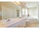 Bright bathroom featuring double sinks, a soaking tub, and a separate shower at 1961 Rocky Pointe Dr, Lakeland, FL 33813