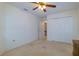 Bright bedroom featuring neutral walls, ceiling fan, carpet flooring, and a closet at 1961 Rocky Pointe Dr, Lakeland, FL 33813