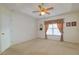 Spacious bedroom with tray ceiling, neutral carpeting, and a large window with curtains at 1961 Rocky Pointe Dr, Lakeland, FL 33813