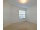 Empty bedroom with carpet, window with blinds, and white trim at 1961 Rocky Pointe Dr, Lakeland, FL 33813