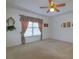 Large bedroom with a ceiling fan, window with curtains, and neutral-toned carpeting at 1961 Rocky Pointe Dr, Lakeland, FL 33813