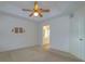 Spacious bedroom featuring a ceiling fan, neutral carpeting, and en-suite bathroom access at 1961 Rocky Pointe Dr, Lakeland, FL 33813