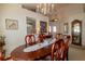 Elegant dining room with a wooden table set for a meal, chandelier, and decorative wall accents at 1961 Rocky Pointe Dr, Lakeland, FL 33813