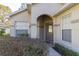 Inviting entryway featuring a decorative glass front door and manicured front garden at 1961 Rocky Pointe Dr, Lakeland, FL 33813