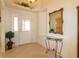 Bright foyer with tile flooring, decorative mirror, and a charming entry table at 1961 Rocky Pointe Dr, Lakeland, FL 33813