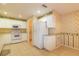 Spacious kitchen featuring white appliances, tiled floors and decorative wallpaper at 1961 Rocky Pointe Dr, Lakeland, FL 33813