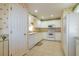 Bright kitchen featuring white appliances, cabinetry, tile floors and decorative wallpaper at 1961 Rocky Pointe Dr, Lakeland, FL 33813