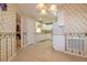 Spacious eat-in kitchen with tile flooring, white cabinetry and floral wallpaper at 1961 Rocky Pointe Dr, Lakeland, FL 33813