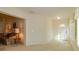 Open-concept living room with neutral carpeting, white walls, and a view into an adjacent sitting area at 1961 Rocky Pointe Dr, Lakeland, FL 33813