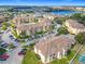 Aerial view of apartments featuring ample parking, landscaping and access to nearby lake at 205 Terrace Ridge Cir # 205, Davenport, FL 33896