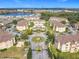 Scenic aerial view of an apartment complex with a central fountain and access to a lake at 205 Terrace Ridge Cir # 205, Davenport, FL 33896